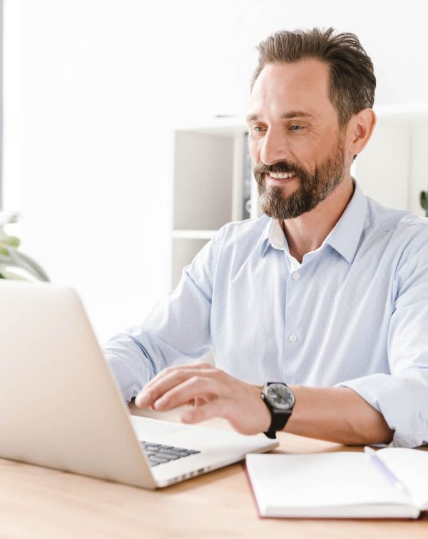 smiling-businessman-working-on-laptop-computer.jpeg